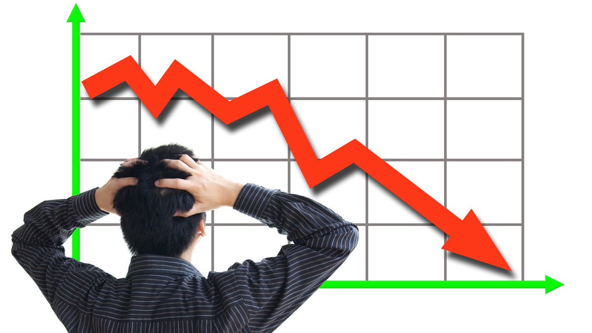 Man looking at downward graph